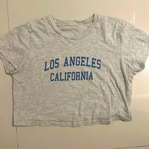 light gray crop top with blue text that says Los Angeles California